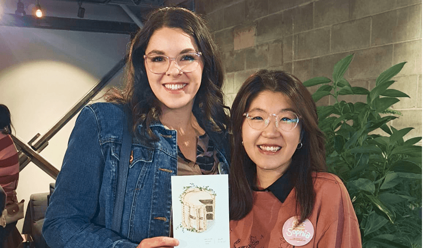 Event attendee receiving illustrated postcard